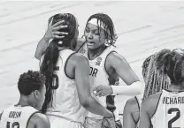  ?? Ronald Cortes / Contributo­r ?? Baylor’s Nalyssa Smith, right, and Queen Egbo survived Michigan in overtime Saturday to set up the Uconn showdown.