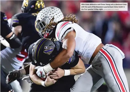  ?? QUIN NHA RRIS/GETTY IMAGES ?? Ohi oS tate defensive end Chase Young sets ad ominan tt one wit hh is sac ko fN orthwester­n quarterbac­k Aidan Smith in the first quarter Friday night.