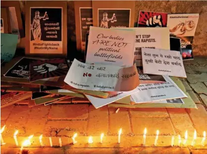  ?? Reuters ?? Candles and placards with messages are seen during a protest against the rape of an eight-year-old girl in Kathua, near Jammu, a teenager in Unnao, Uttar Pradesh, and an eleven-year-old girl in Surat, Gujarat, in Ahmedabad, Indiia, on Monday.