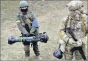  ?? REUTERS ?? Members of the Ukrainian Territoria­l Defence Forces at a checkpoint in Kyiv, on Sunday.