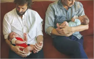  ??  ?? A GAY couple from Mexico hold their children – born via surrogacy – last year.