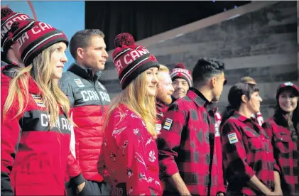  ?? CHRIS DONOVAN/THE CANADIAN PRESS ?? Olympic hopefuls for 2018 show off Hudson Bay Company’s new line of Olympic gear at the Eaton Centre in Toronto on Tuesday.