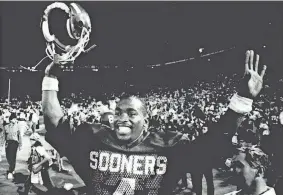  ?? OKLAHOMAN FILE PHOTO ?? With an Orange Bowl victory and national title secured, OU quarterbac­k Jamelle Holieway enjoys the moment on Jan. 1, 1986.