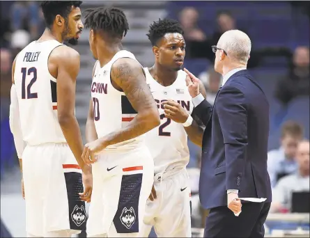  ?? Jessica Hill / Associated Press ?? UConn coach Dan Hurley speaks with Tarin Smith during a timeout in a game earlier this season. The Huskies return to action on Saturday against Manhattan.