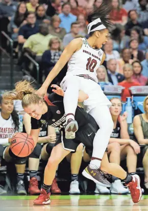  ?? ASSOCIATED PRESS ?? South Carolina guard Allisha Gray lands on Stanford guard Brittany McPhee as McPhee tries to maintain control of the basketball Friday night. Gray led the Gamecocks with 18 points.