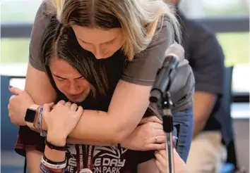  ?? AMY BETH BENNETT/SUN SENTINEL ?? Marjory Stoneman Douglas student Macie Chapman comforts fellow student Sarah Stricker as she breaks down Wednesday while listening to accounts of the massacre that took place at the school in February. During a gun violence roundtable at Coral Springs City Hall, House Minority Leader Nancy Pelosi — joined by U.S. Rep. Ted Deutch, D-West Boca — promised South Florida gun-control activists that universal background checks would be among Democrats’ top priorities if the party wins control of the House in the midterm elections.