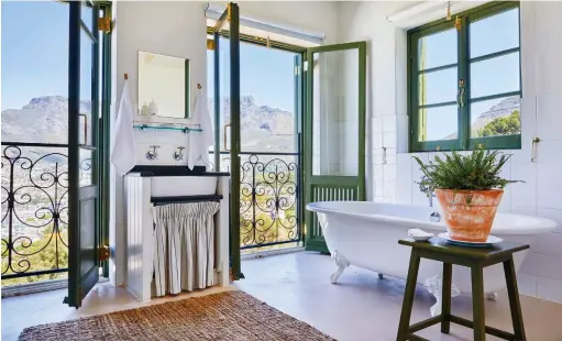  ??  ?? CLOCKWISE FROM ABOVE The spectacula­r view of Table Mountain from The Moon family suite; the Rose House bathroom features a Hydrofire wood-burning fireplace; The Moon suite’s kitchen with distressed tile blocks that were found at a local tile shop.