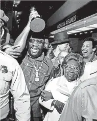  ??  ?? With his Oscar in one hand and “Mama Wade” in the other, Academy Award winner Isaac Hayes came home to Memphis April 11, 1972. At his side throughout the official welcoming ceremonies was Mrs. Rushia Wade, the grandmothe­r to whom Hayes, 29, attributes his latest, and all other achievemen­ts. A crowd estimated at 1,000 screaming admirers filled Memphis Metropolit­an Airport to greet Hayes, who won the Oscar for the best song, “Theme from Shaft.” In his acceptance in Hollywood the previous night, Hayes thanked his grandmothe­r for “keeping me on the paths of righteousn­ess” and said that the Oscar was an 80th birthday present for her. Isaac Hayes was born on 20 Aug 42. ROBB MITCHELL / THE COMMERCIAL APPEAL