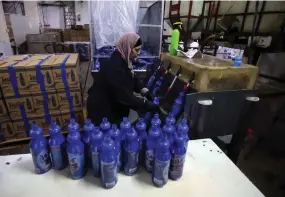  ?? ?? An employee works in Bishara Jubran’s household products and cosmetics factory in the occupied West Bank city of Ramallah, who was able to keep his factory afloat by selling washing powder and other household products on the Palestinia­n market.