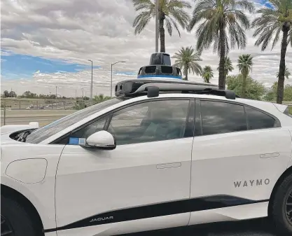  ?? NEIL STEINBERG/SUN-TIMES ?? A Waymo driverless taxi on the street in Phoenix last week. Run by Google, the fleet of autonomous taxis is operating in San Francisco and Phoenix. They’re also headed to Los Angeles and, eventually, Chicago.