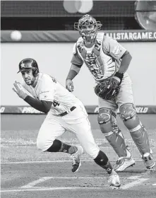  ?? Ron Schwane / Associated Press ?? George Springer is off to the races after leading off the American League’s half of the first inning with a single.