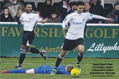  ?? Picture: Chris Davey FM5019143 ?? Faversham’s Dan Carrington leaves a Greenwich player grounded on Saturday