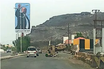  ?? AFP ?? ROAD TO PEACE: Cars driving beneath a large billboard showing President Abd-Rabbu Mansour Hadi along a road in Yemen’s second city of Aden. —