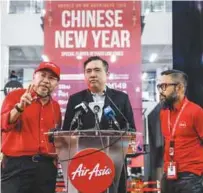  ?? – ASHRAF SHAMSUL/THE SUN ?? From left: AirAsia executive chairman Datuk Kamarudin Meranun, Minister of Transport Anthony Loke and Riad at the event announcing the special flights and fares yesterday.