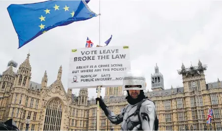  ??  ?? A Brexit opponent dressed as a “Robocop” demonstrat­es Monday outside Britain’s Houses of Parliament in London.