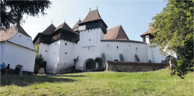  ?? PHOTOS: LUCY HYSLOP ?? Weissekhir­che ( white church) is an impressive fortified UNESCO World Heritage site in Viscri, high on a hill. Its medieval Lutheran church towers look over the village.