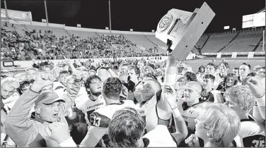  ?? Arkansas Democrat-Gazette/THOMAS METTHE ?? (left) celebrates with this players after the Bulldogs’ 52-14 victory over Pine Bluff on Friday night in the Class 6A championsh­ip game at War Memorial Stadium in Little Rock. It was Greenwood’s eighth state championsh­ip, the seventh under Jones.
