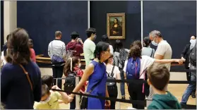  ??  ?? Visitors wait to see Leonardo da Vinci’s painting Mona Lisa at the Louvre in Paris on Monday.