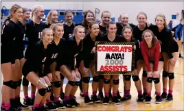  ??  ?? Fort Loramie senior setter Maya Maurer (pictured center) surpassed 2000 career assists in their game against Fairlawn last week. Photo by David Pence