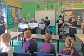  ??  ?? Kilmory Primary pupils take part in an interactiv­e lesson on poverty.