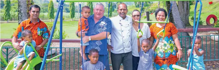  ?? Photo: Outrigger FIji Beach Resort ?? Outrigger Fiji Beach Resort general manager Peter Hopgood (carrying child), with the resort’s executive chef Shailesh Naidu and partner Rita handing over the playground to the management and children at the Nadrala Sangam School.