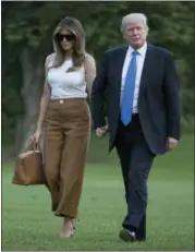  ??  ?? President Donald Trump and first lady Melania Trump walk across the South Lawn to the White House in Washington Sunday.