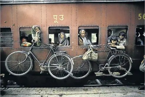  ?? Pictures: Magnum Photos/Steve McCurry ?? Bicycles hanging on the side of a train, West Bengal, India, 1983.