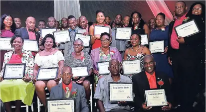  ??  ?? Employees of Jamaica Inn, who have served between 10-19 years at the Ocho Rios resort, pose with their plaques and gift certificat­es at the hotel’s 60th anniversar­y awards ceremony.