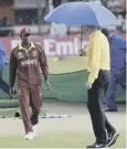  ??  ?? 0 Players leave the field as rain hands victory to the West Indies.