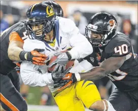  ??  ?? Oregon State’s Michael Doctor (right) helps bring down California’s Darius Powe during the first half of their Nov. 17 meeting. The junior linebacker will enter the Alamo Bowl against Texas with a team-high 72 tackles.