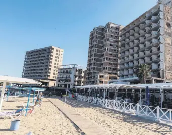  ??  ?? People spend time at the seaside in the fenced-off area of Varosha (Maraş) in the Turkish Republic of Northern Cyprus (TRNC), June 19, 2021.