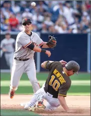  ?? HAYNE PALMOUR IV/TRIBUNE NEWS SERVICE ?? San Francisco Giants second baseman Joe Panik throws to first to turn a double play over the San Diego Padres' Hunter Renfroe in the fifth inning at Petco Park in San Diego on Friday. The Padres won, 7-6.