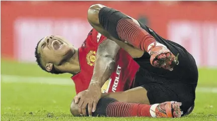  ?? (Photos: AFP) ?? Manchester United’s English striker Marcus Rashford reacts after taking a knock in a challenge during the English Premier League match against Brighton and Hove Albion at Old Trafford in Manchester, north-west England, yesterday.