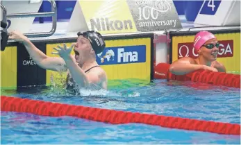  ?? DARKO BANDIC, AP ?? The USA’s Lilly King, left, celebrates after setting a world record in the women’s 100-meter breaststro­ke final and beating Russian rival Yuliya Efimova at the world championsh­ips.