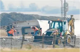  ?? TED S. WARREN/AP ?? Workers clear debris two days after an Amtrak train derailed Sept. 25, 2021, near Joplin, Mont. Three passengers died and two others were seriously injured in the crash.