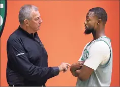  ?? John Tlumacki / Boston Globe via Getty Images ?? Former UConn coach Jim Calhoun talks with former player Kemba Walker of the Celtics during a practice last year in Boston.