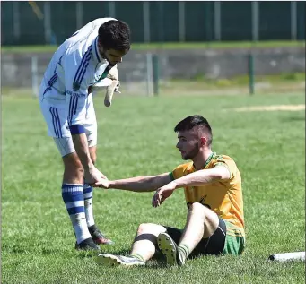  ??  ?? Gneeveguil­la’s Philip Cremin is consoled by Laune Rangers goalie Jason Browne at the end of the County Intermedia­te Championsh­ip relegation play-off final in Lewis Road, Killarney on Sunday.
Photo by Michelle Cooper Galvin