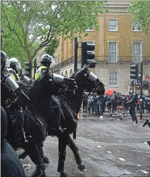  ??  ?? OFFICER DOWN: The shocking moment when a policewoma­n was seriously hurt last weekend after her horse bolted during violent clashes in Central London