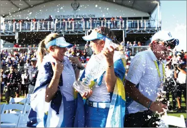  ?? Maddie Meyer
/ Getty Images /TNS ?? Anna Nordqvist ofteam Europe and Madelene Sagstrom ofteam Europe celebrate with the Solheim Cup after winning overteam USA during day three of the Solheim Cup at the Inverness Club on Monday intoledo, Ohio.