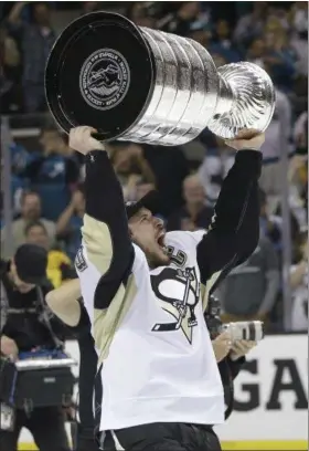  ?? MARCIO JOSE SANCHEZ — THE ASSOCIATED PRESS ?? Pittsburgh Penguins center Sidney Crosby celebrates with the Stanley Cup after Game 6 of the Stanley Cup finals against the Sharks in San Jose Sunday. The Penguins won, 3-1, to win the series, 4-2.
