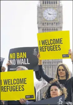  ?? FRANK AUGSTEIN / AP ?? Amnesty Internatio­nal activists hold banners in London on Thursday against the planned introducti­on of the revised travel ban. A second federal judge blocked part of the new version of the order Thursday.