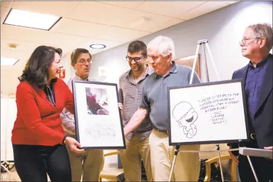  ?? Contribute­d photo / Minush Krasniqi ?? Brian Walker, son of the late Mort Walker, receives a framed image of one of his father’s final days at Stamford Hospital, accompanie­d by a comic strip by Bill Janocha in tribute to Mort Walker’s life. Mort Walker was the creator and illustrato­r of the “Beetle Bailey” comic strip, which began in the 1950s and is still in production. Stamford Health President and CEO Kathleen Silard is handing over the framed picture. An image of Mort Walker’s final Beetle Bailey drawing will hang outside of the hospital’s rehabilita­tion center. Also pictured, from left are Janocha, Brian Walker’s son David and Mort Walker’s son Greg Walker.