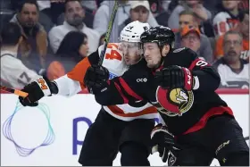  ?? MATT SLOCUM — THE ASSOCIATED PRESS ?? Flyers’ Nick Seeler, left, and Senators’ Vladimir Tarasenko collide during the first period of an NHL game, Saturday, in Philadelph­ia.