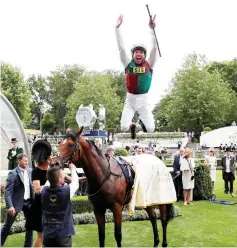  ?? — Reuters photo ?? Frankie Dettori jumps off Without Parole as he celebrates winning the 4.20 St James’ Palace Stakes.