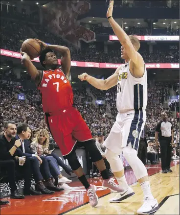  ?? JACK BOLAND/TORONTO SUN ?? Raptors guard Kyle Lowry tries to stay inbounds against Nuggets’ Mason Plumlee Tuesday at the ACC. Lowry and teammate DeMar DeRozan combined for 16 assists last night.