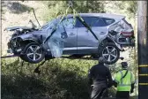  ?? RINGO H.W. CHIU — THE ASSOCIATED PRESS FILE ?? A crane is used to lift a vehicle following a rollover involving golfer Tiger Woods in the Rancho Palos Verdes suburb of Los Angeles.