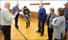  ?? Photo by Mike Eckels ?? Decatur Mayor Bob Tharp (left) showed members of the Decatur City Council and other department heads the floor in the community room on Feb. 13. The council voted to renovate the floors, restrooms and kitchen in the City Hall facility.