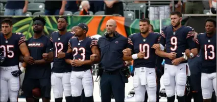  ??  ?? The Chicago Bears lock arms during the national anthem before the team’s NFL preseason football game against the Cincinnati Bengals, on Thursday, in Cincinnati. AP PhoTo/FrAnk VIcToreS