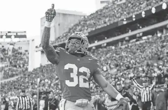  ?? ADAM CAIRNS/THE COLUMBUS DISPATCH ?? Ohio State running back TreVeyon Henderson celebrates a touchdown against Minnesota on Nov. 18.