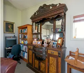  ??  ?? Hickey was once an antique dealer, and this is reflected in many of the pieces within his home. The mottled kauri, mirrorback­ed sideboard, above, is an heirloom piece.